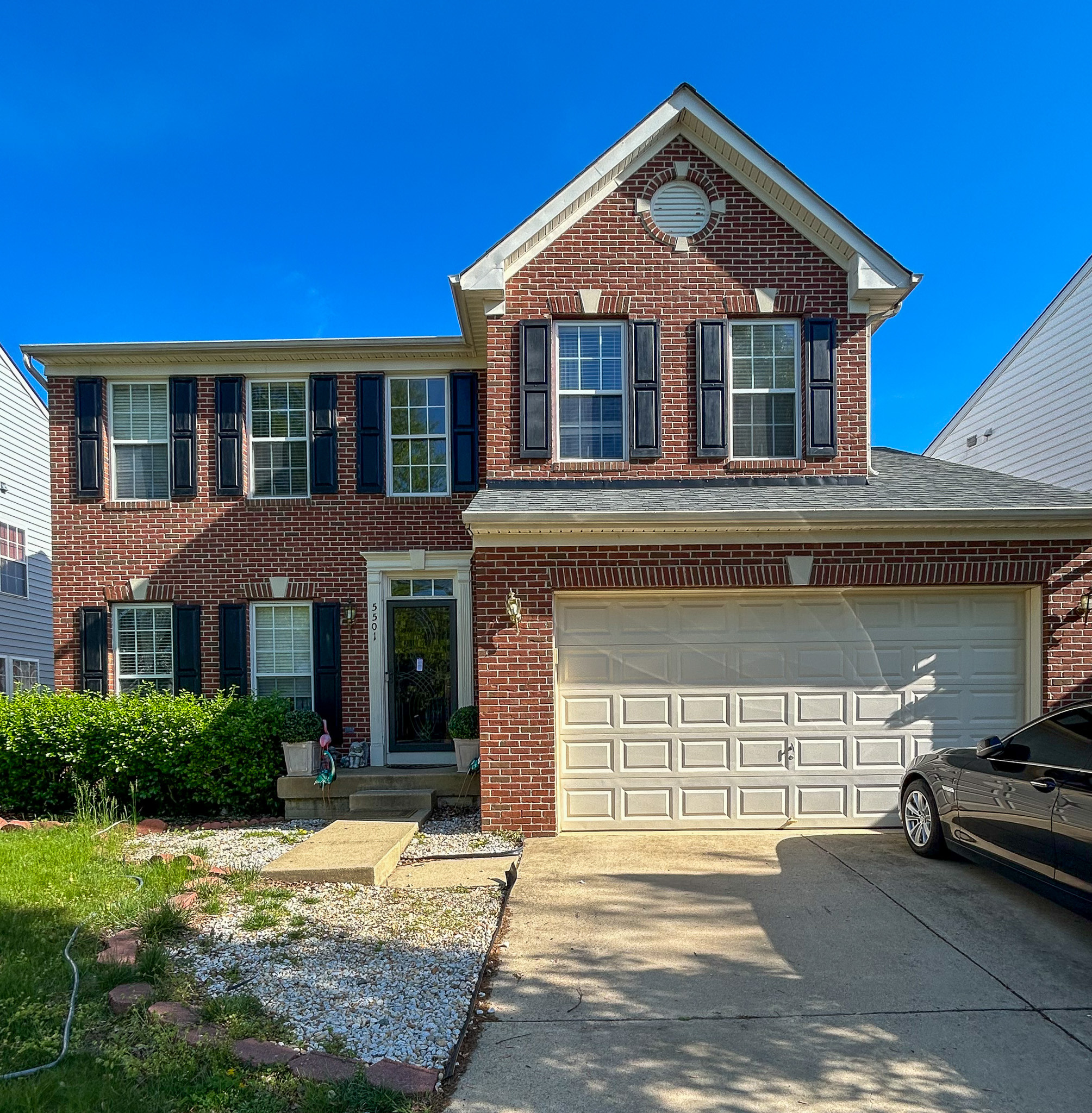Exterior front view of a two-story brick home with a two-car garage and driveway belonging to Sponsored Residential Provider Aidah Brassier in Spotsylvania, VA.