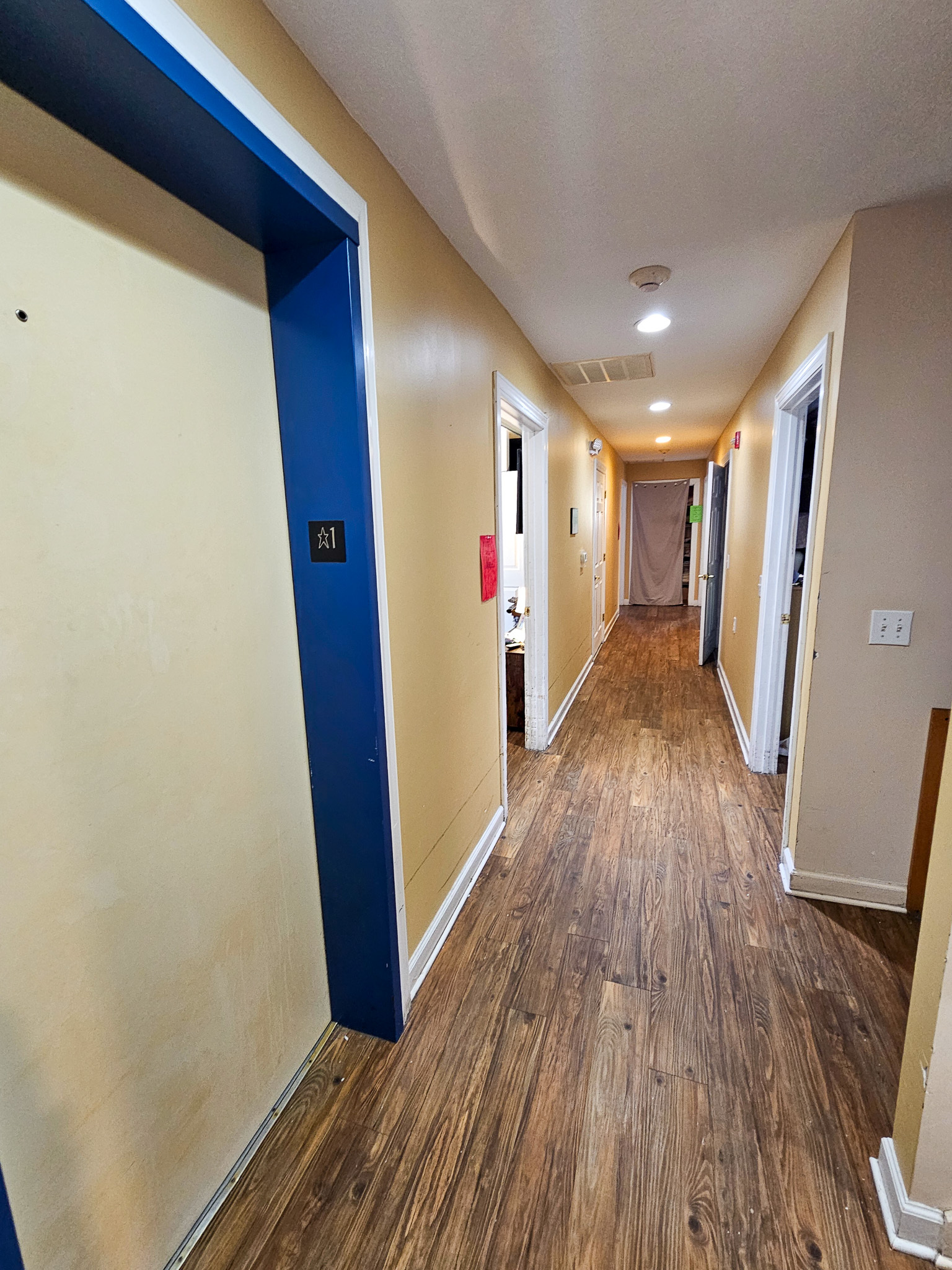 An elevator at the foreground of a wide hallway leading to bedrooms at the Boonsboro Group Home in Lynchburg, Virginia.