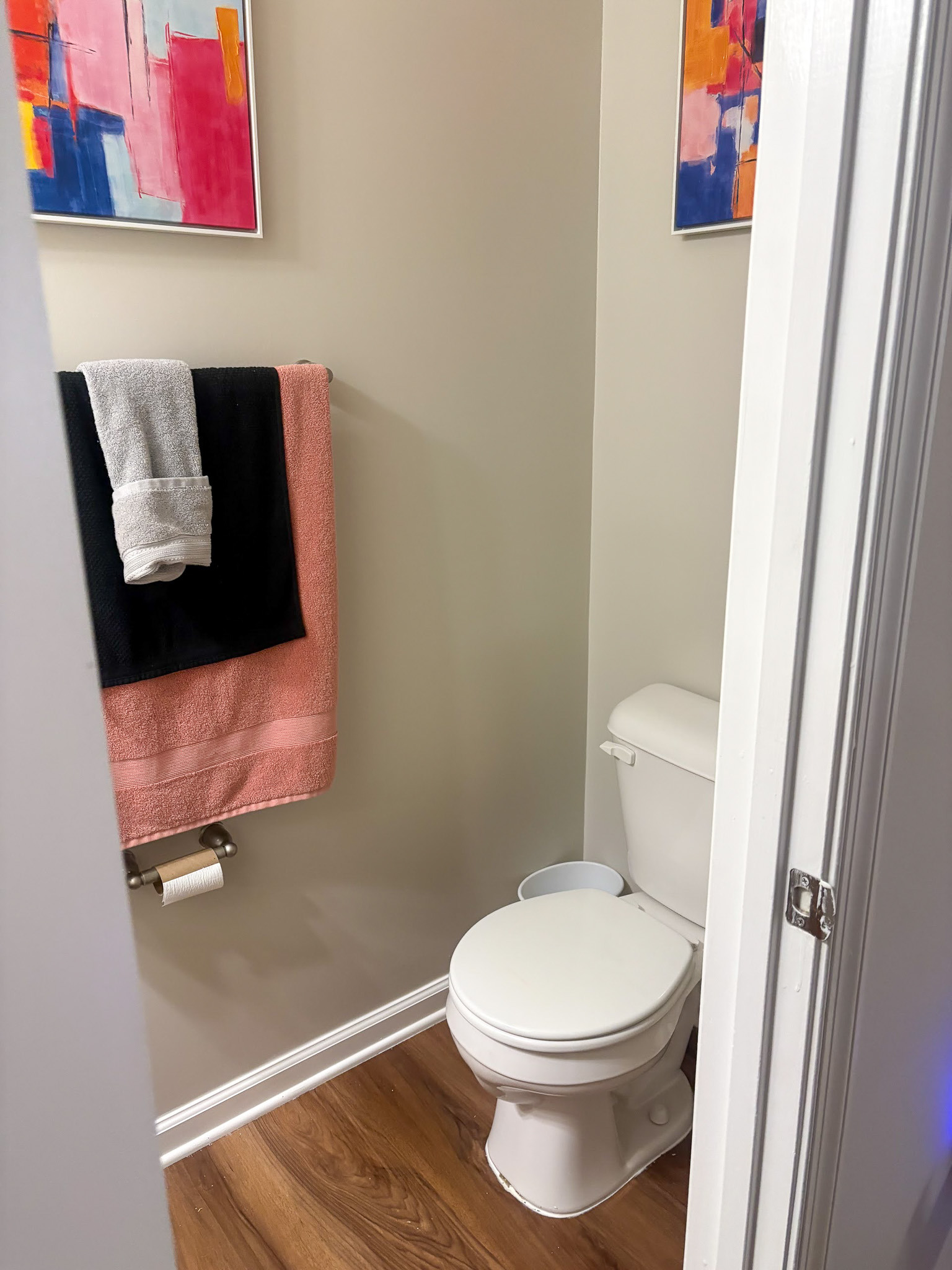 Compact bathroom with a toilet, towel rack, and patterned shower curtain inside the home of Sponsored Residential provider Cynthia Kimbrough-Mabry in Chester, Virginia