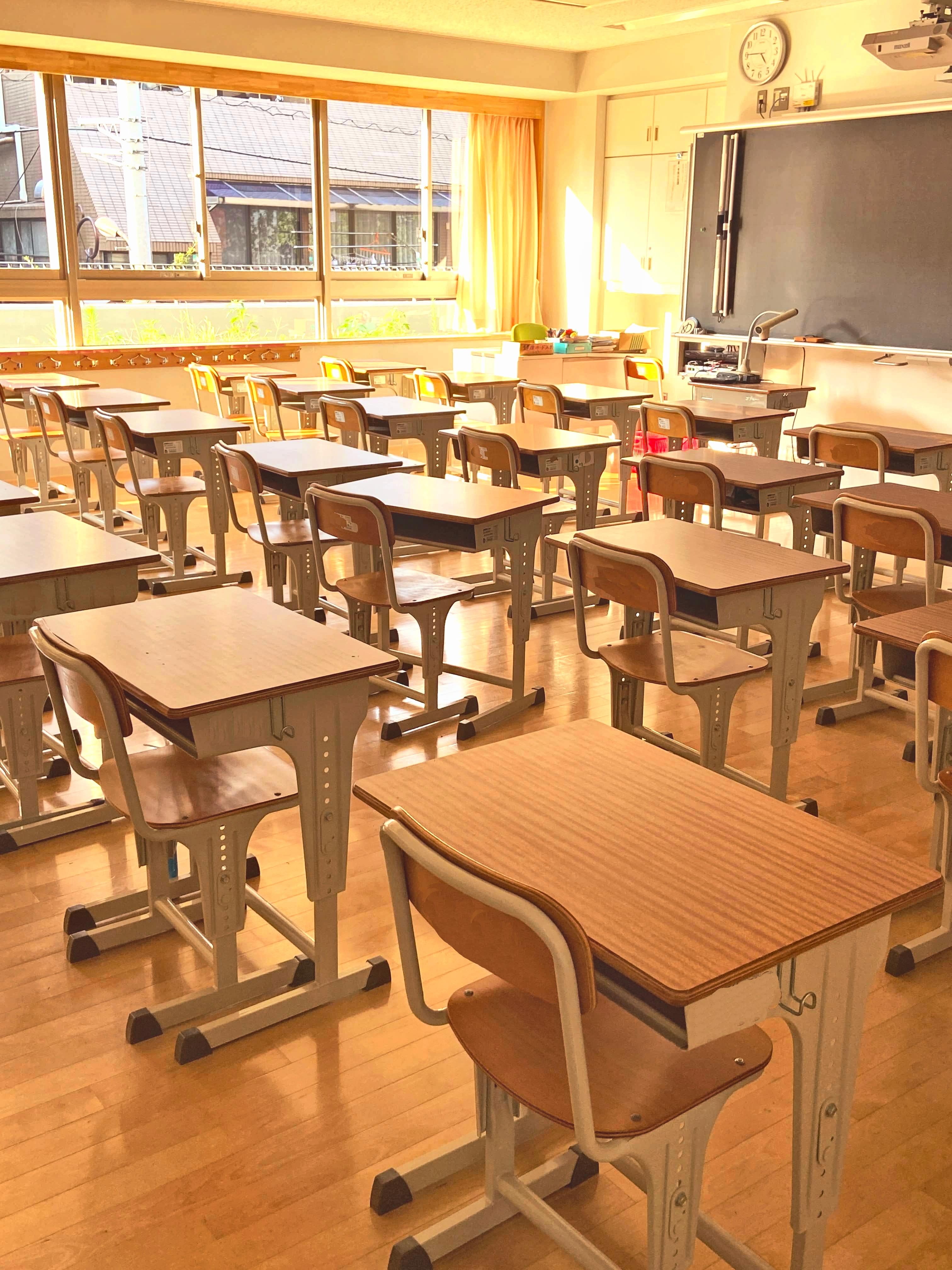 Empty desks and chairs in an empty classroom.