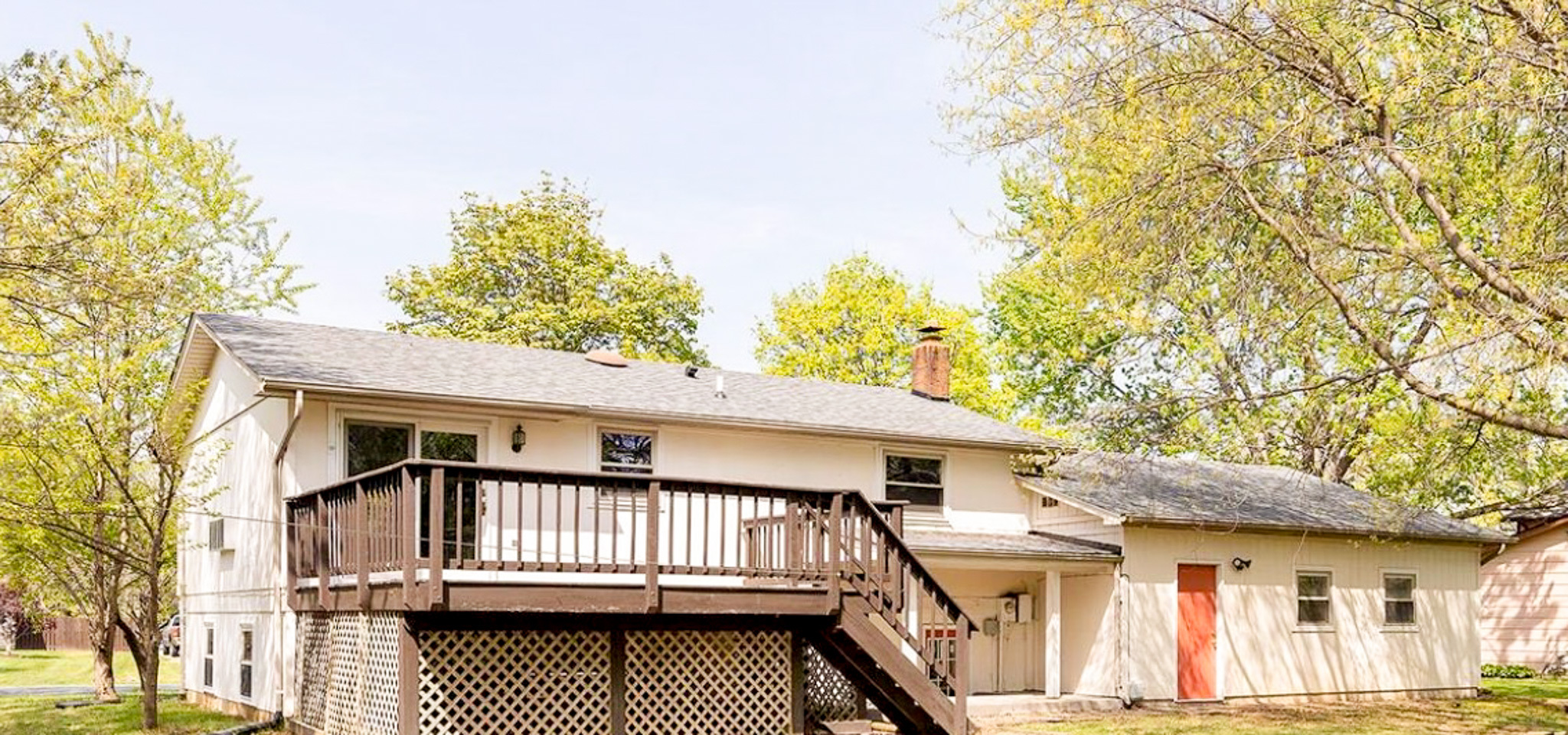 Rear view of a split‑level house with a wooden deck with lattice skirting belonging to Sponsored Residential Providers Daynesha and Karen Wilson in Stephens City, Virginia.