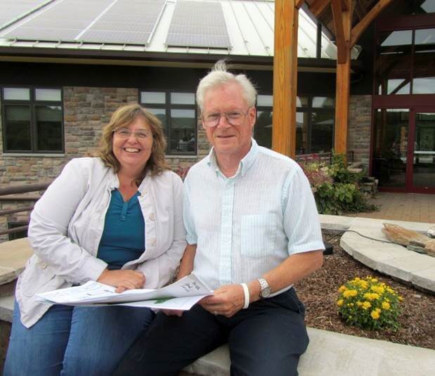 The founders of Wall sitting outside Wall Floyd office smiling at camera