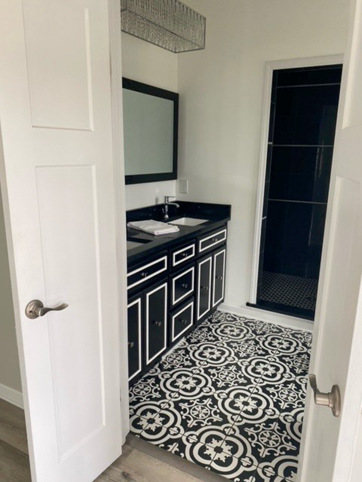 Stylish bathroom at Jake and Angie Beamer’s provider group home in Hillsville, Virginia, featuring a modern vanity, patterned tile flooring, and a walk-in shower.