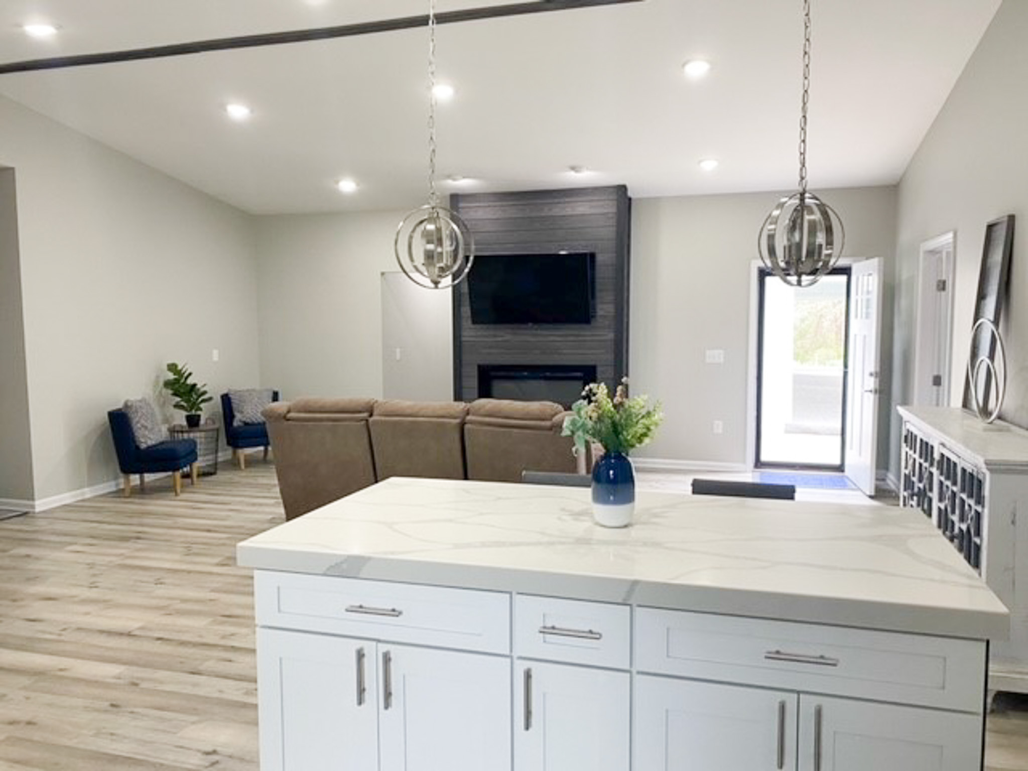 Open-concept living area at Jake and Angie Beamer’s provider group home in Hillsville, Virginia, with a spacious kitchen island, comfortable seating, and a fireplace.