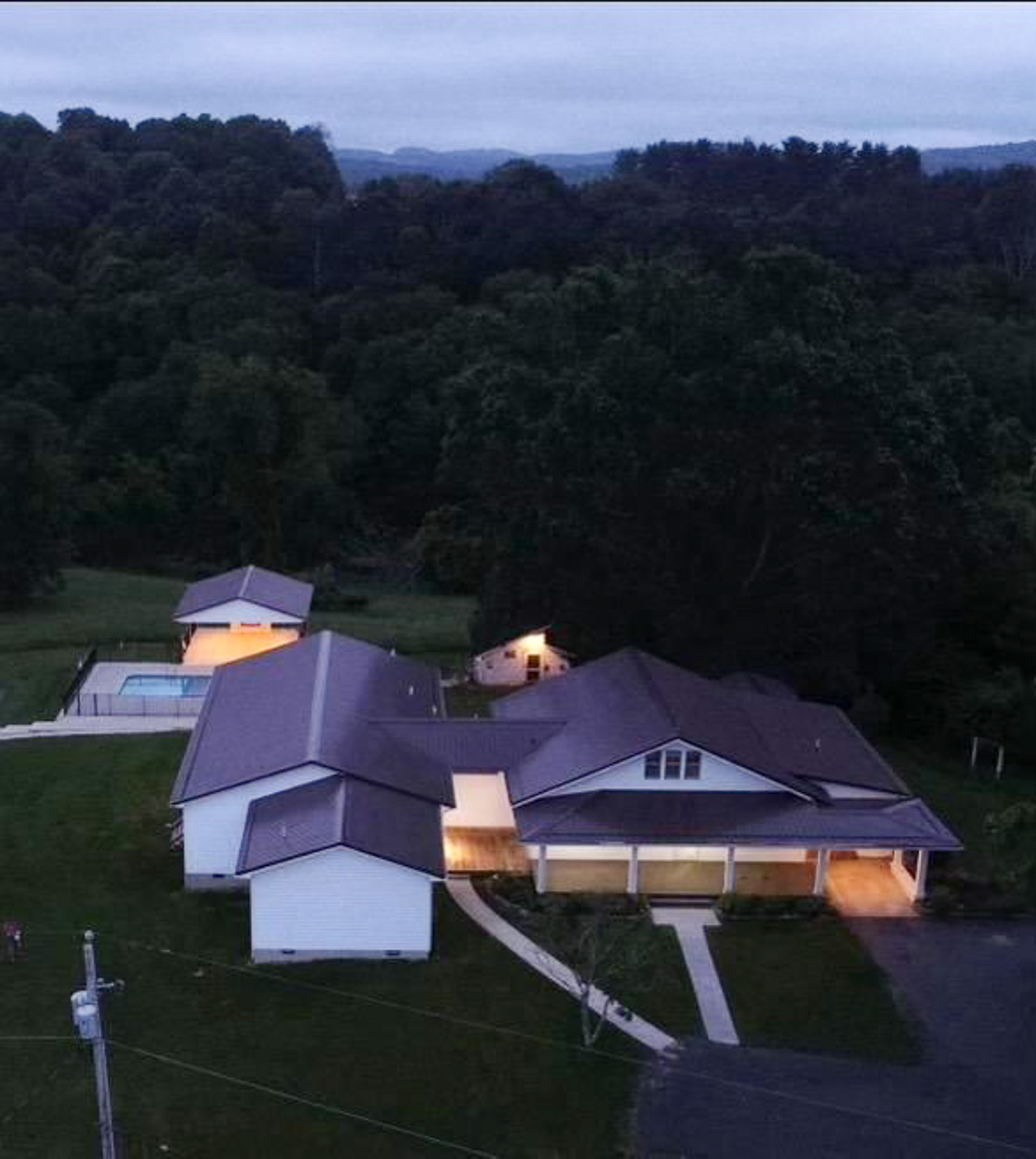 Aerial view of Jake and Angie Beamer’s provider group home in Hillsville, Virginia, showcasing the residence, surrounding wooded landscape, and outdoor amenities.