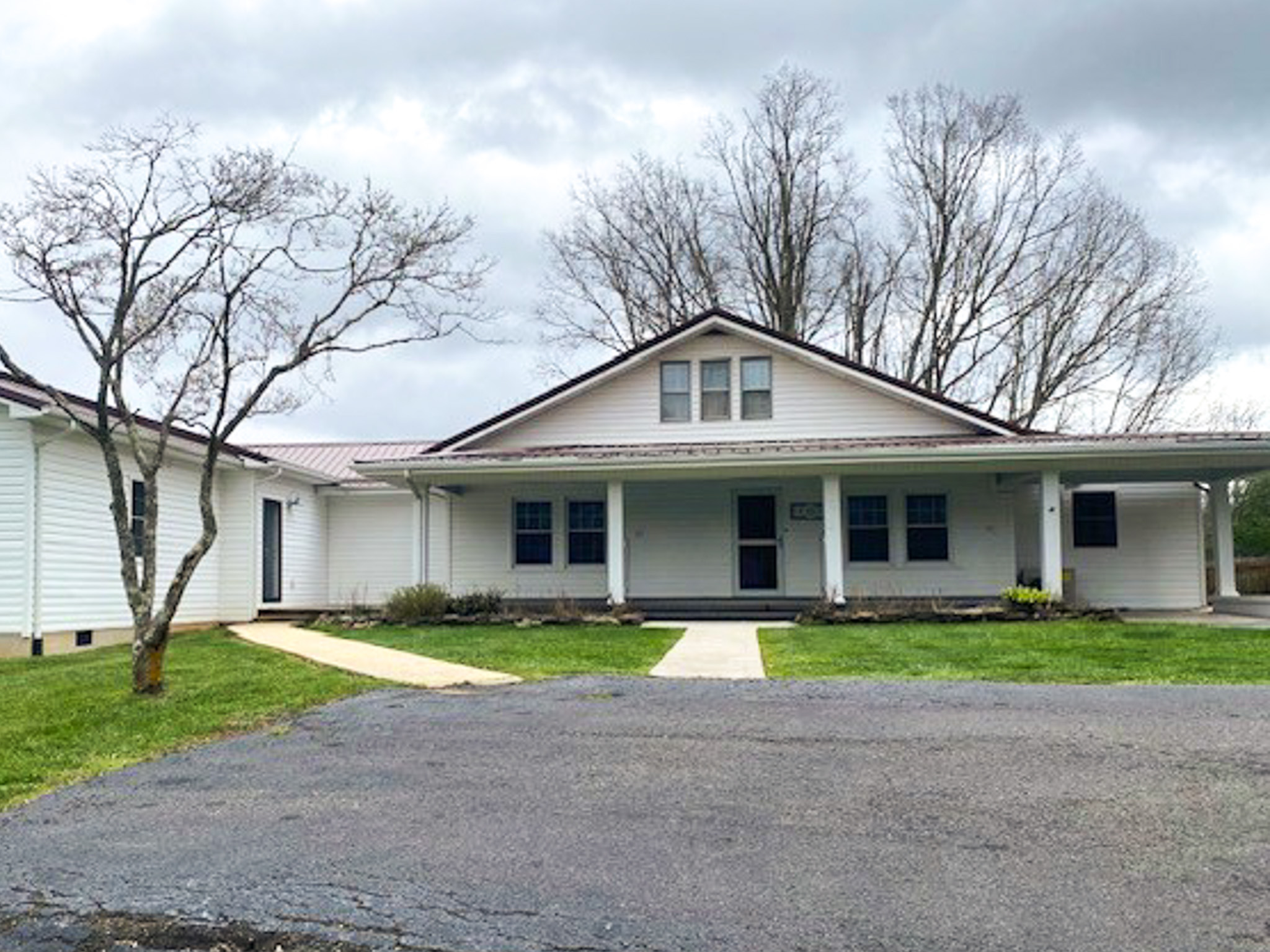 Jake and Angie Beamer’s provider group home in Hillsville, Virginia, featuring a large white residence with a covered front porch, accessible walkways, and a paved driveway.