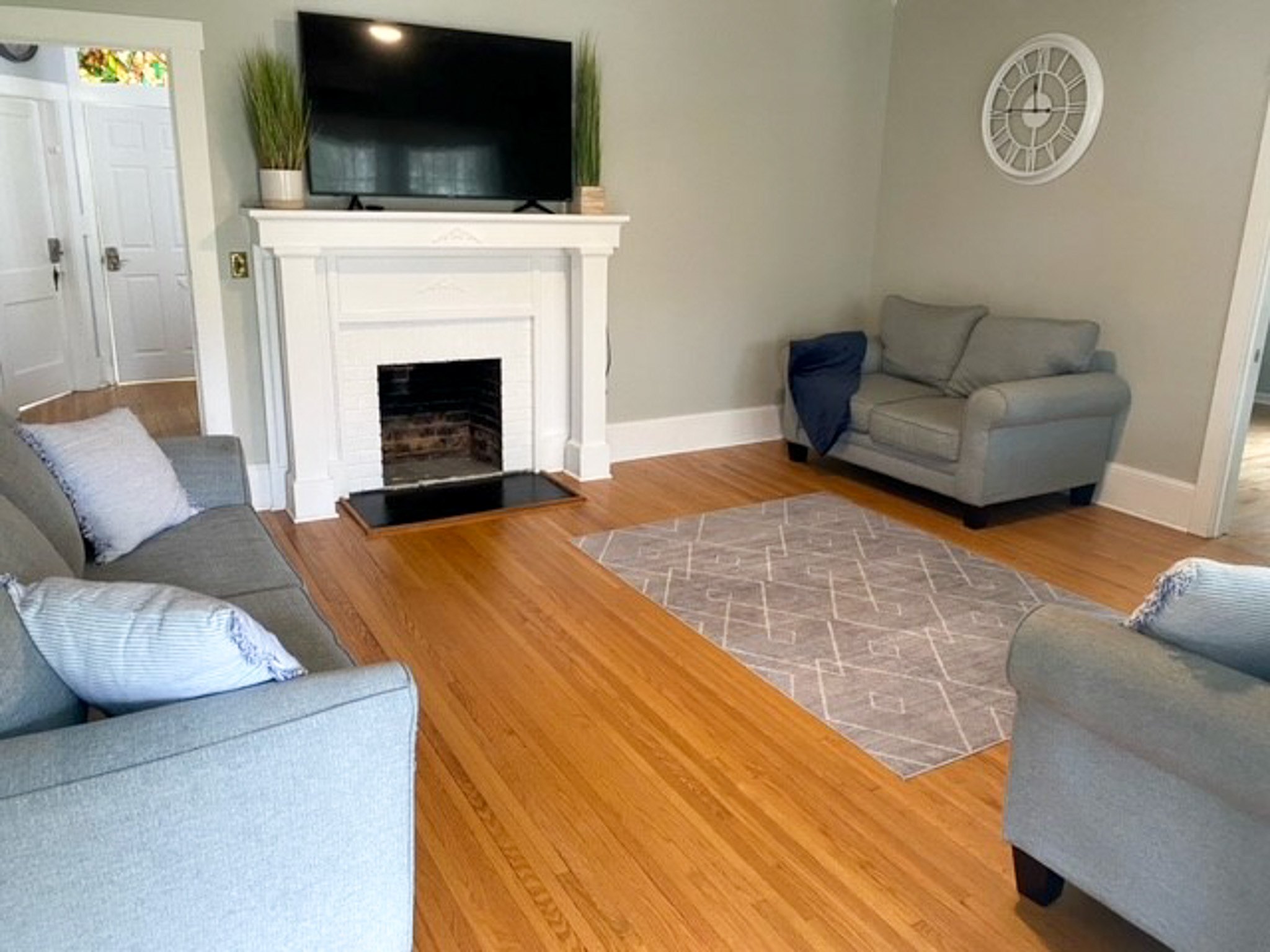 Comfortable living room at Jake and Angie Beamer’s provider group home in Hillsville, Virginia, featuring seating, a fireplace, and a television.