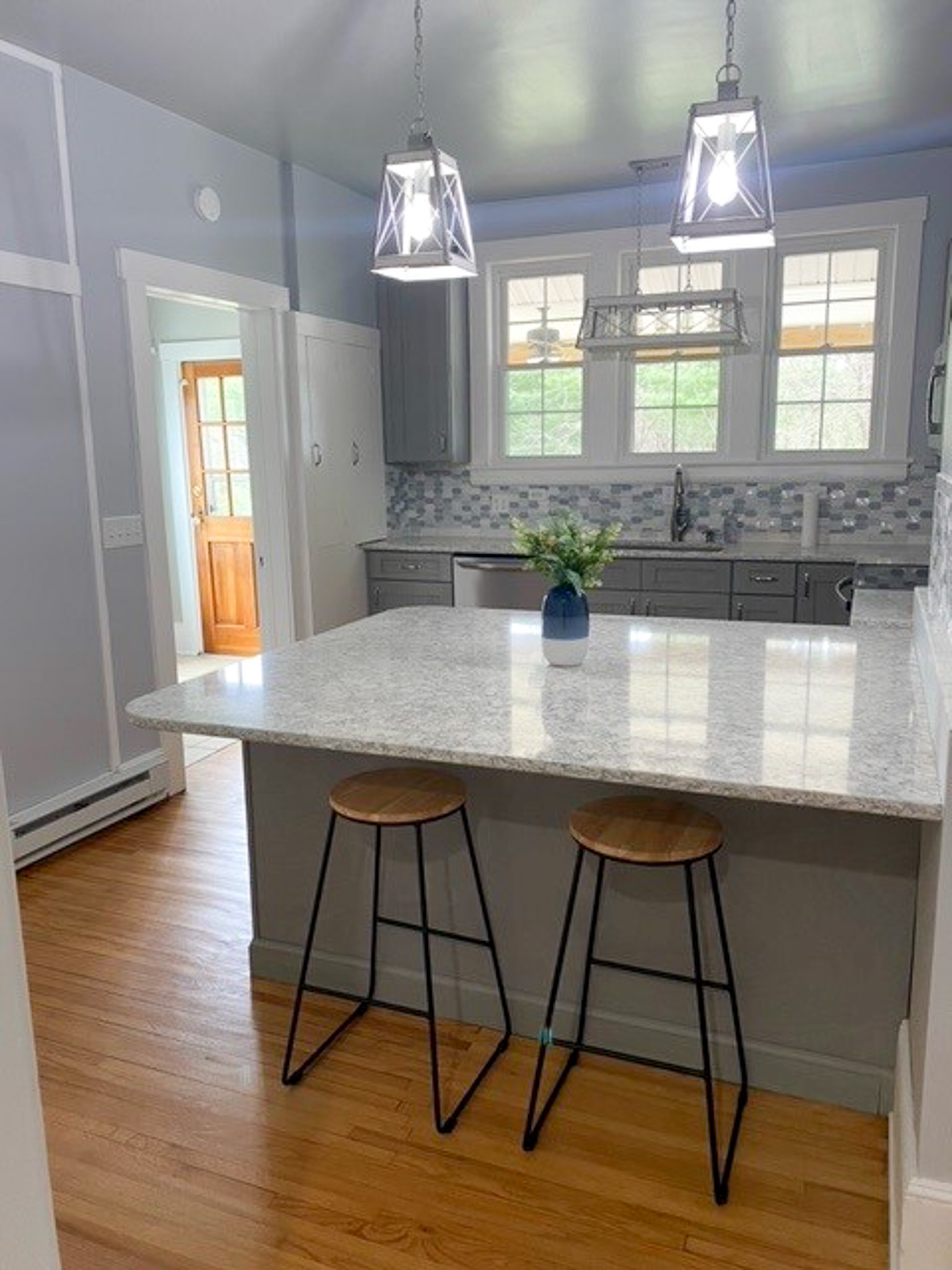 Bright, modern kitchen in Jake and Angie Beamer’s provider group home in Hillsville, Virginia, with a large island, seating, and updated finishes.