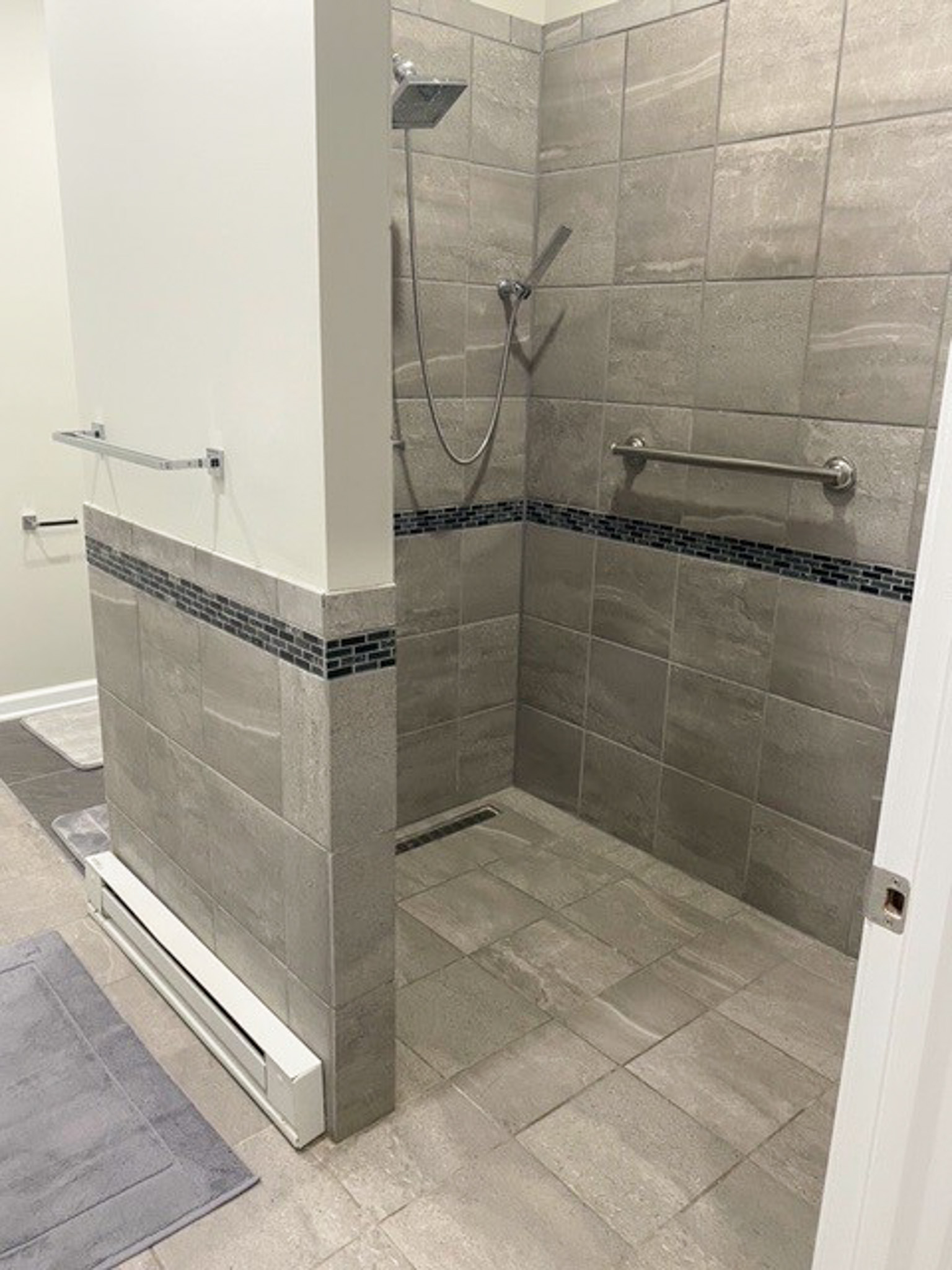 Accessible bathroom at Jake and Angie Beamer’s provider group home in Hillsville, Virginia, with a roll-in tiled shower, grab bar, and barrier-free design.