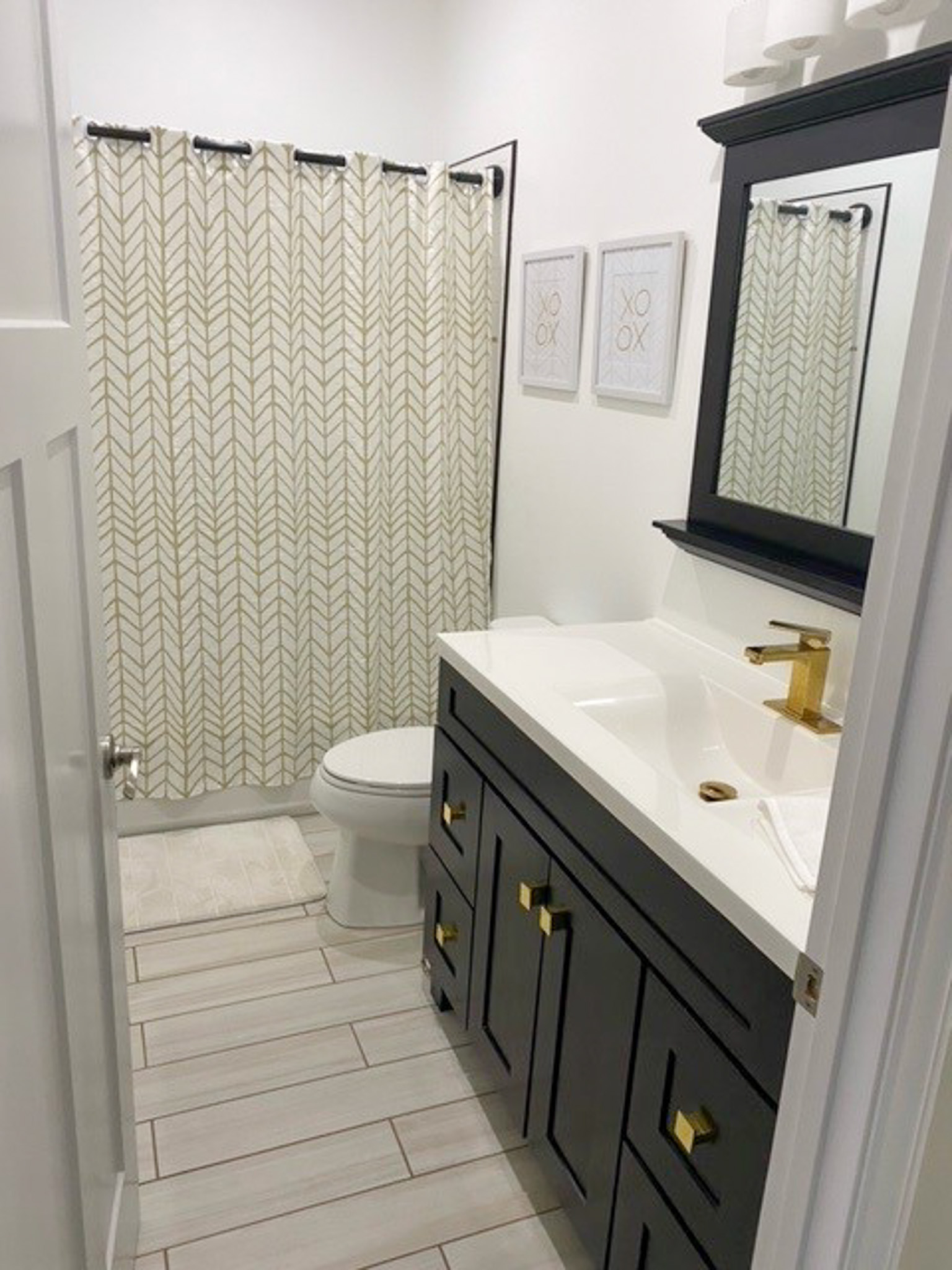 Modern bathroom at Jake and Angie Beamer’s provider group home in Hillsville, Virginia, featuring a large vanity, shower-tub combination, and bright finishes.