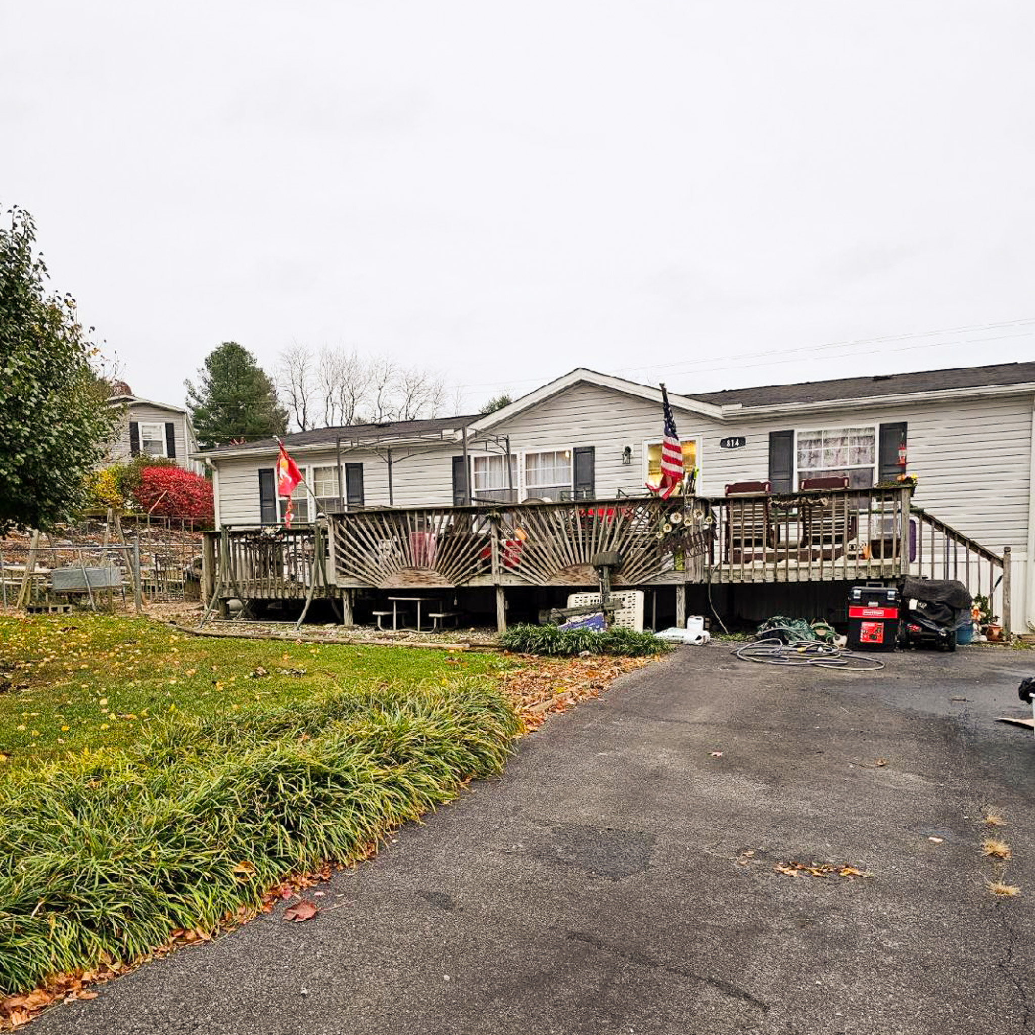 Sponsored Residential Providers Janice and Kenny Cox's home in Willis, Virginia, featuring one-level living, a spacious front porch, and a paved driveway in a peaceful rural setting.
