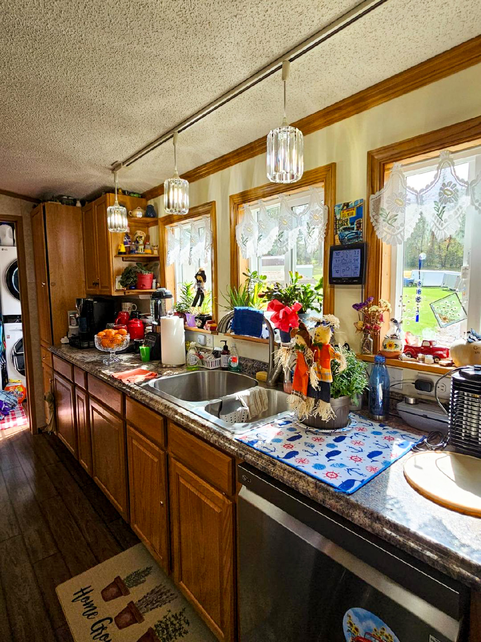 Kitchen in the home of Sponsored Residential Providers Janice and Kenny Cox in Willis, Virginia, featuring wood cabinetry, ample counter space, and natural light from multiple windows.