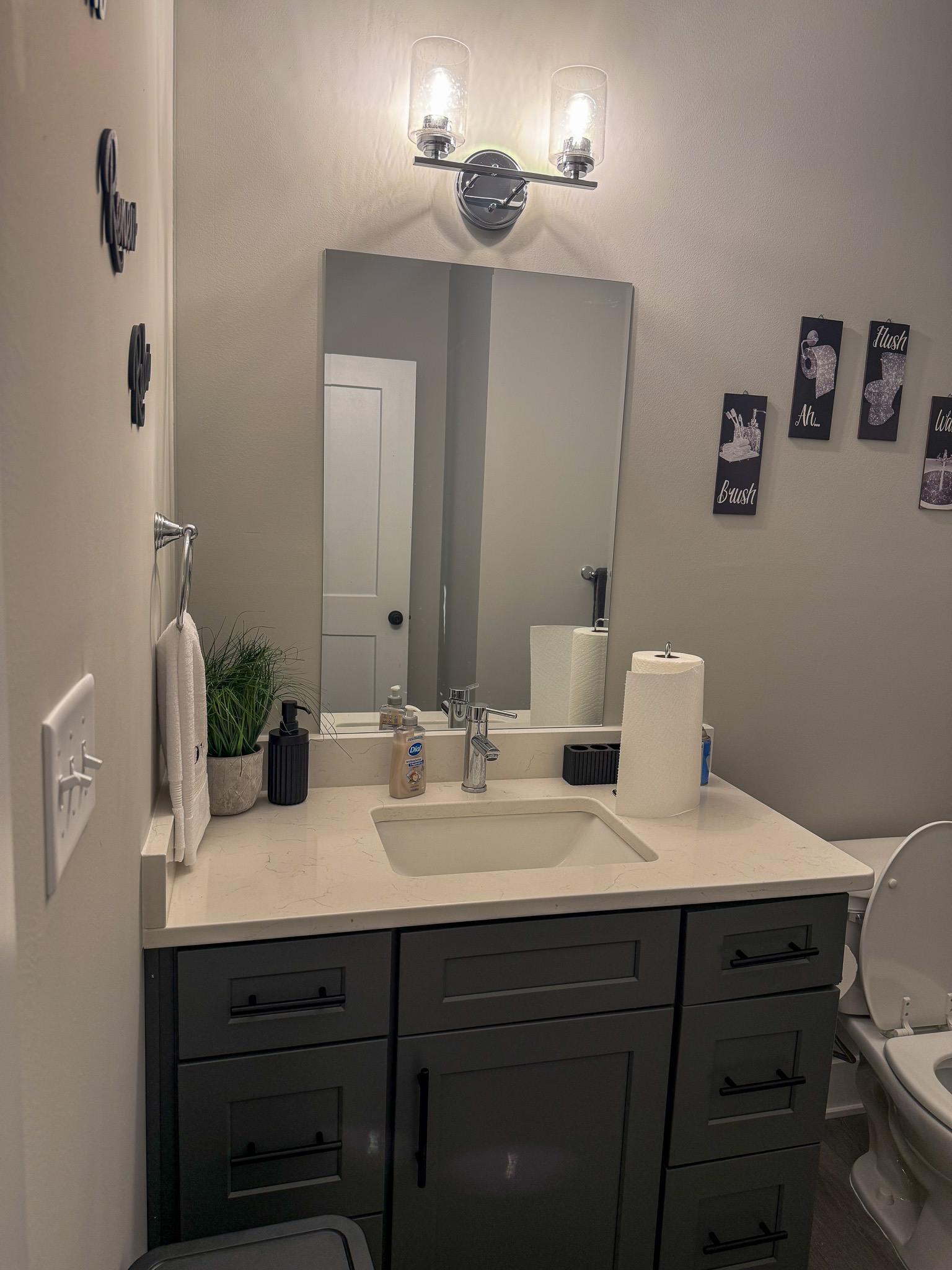 Modern bathroom vanity with sink, storage cabinets, and updated fixtures in the home of Sponsored Residential Provider Justina Megginson in Roanoke, Virginia.