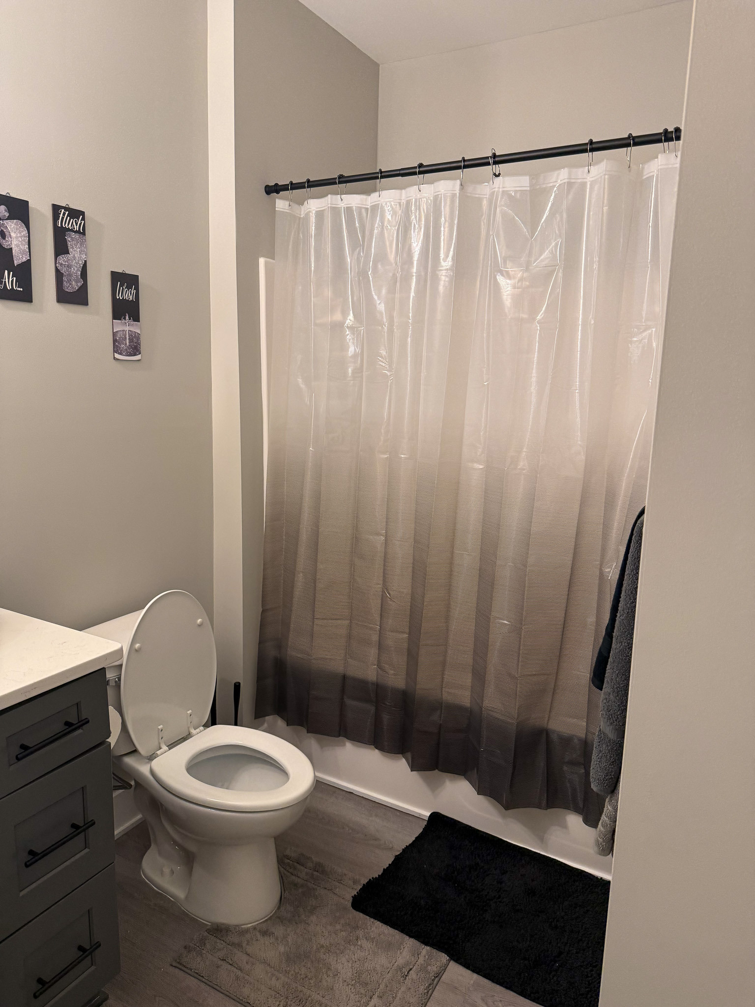 Bathroom with tub/shower, modern vanity, and gray finishes in the home of Sponsored Residential Provider Justina Megginson in Roanoke, Virginia.