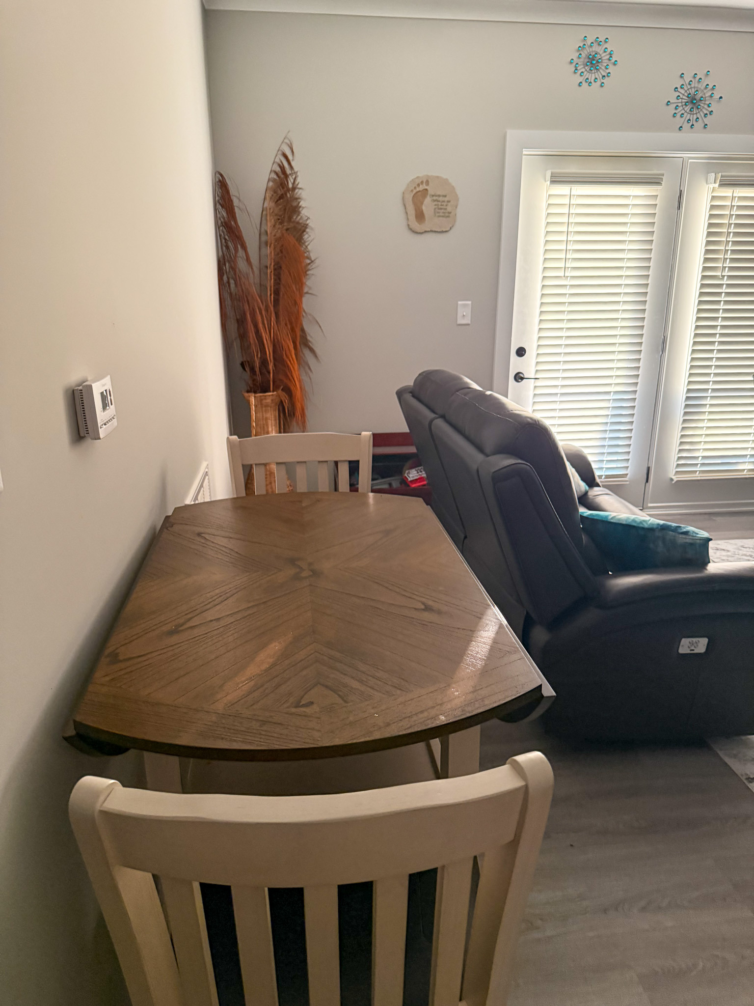Dining area with a wood table and seating adjacent to the living room in the home of Sponsored Residential Provider Justina Megginson in Roanoke, Virginia.