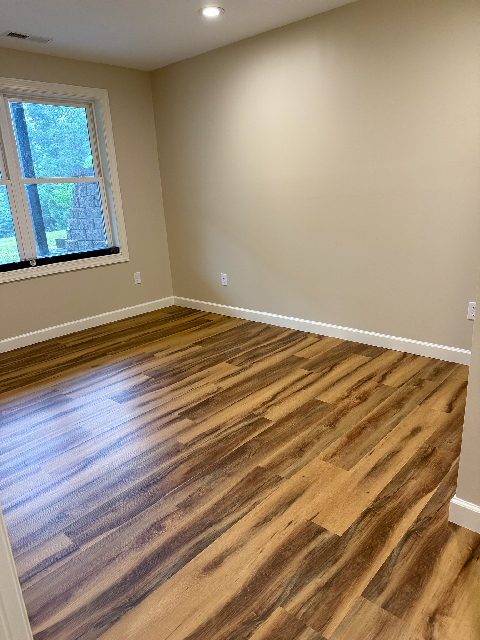 Bright, spacious room with wood flooring and a large window in the home of Wall Group Home provider Lisa Lohr in Harrisonburg, VA.