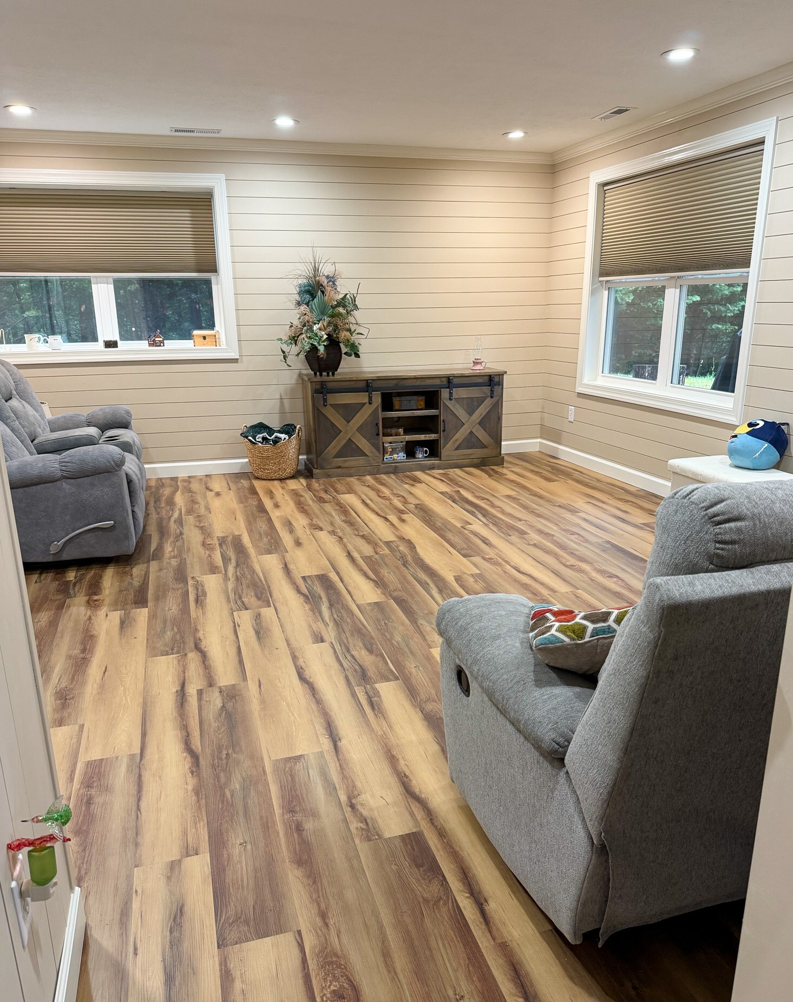 Spacious common area with recliners, wood flooring, and large windows in the home of Wall Group Home provider Lisa Lohr in Harrisonburg, VA.