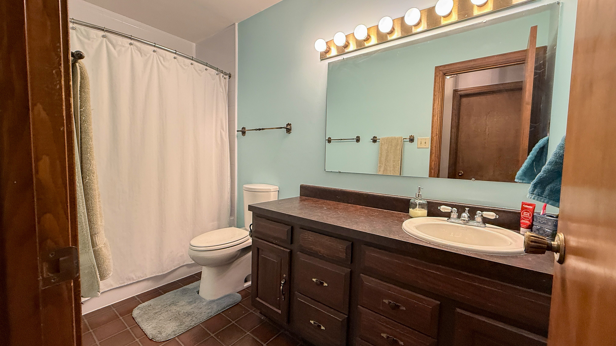 Full bathroom with a vanity, shower-tub combination, and ample storage inside the home of Sponsored Residential Providers Anna Robertson and Christopher Pietrzyk in Roanoke, VA.