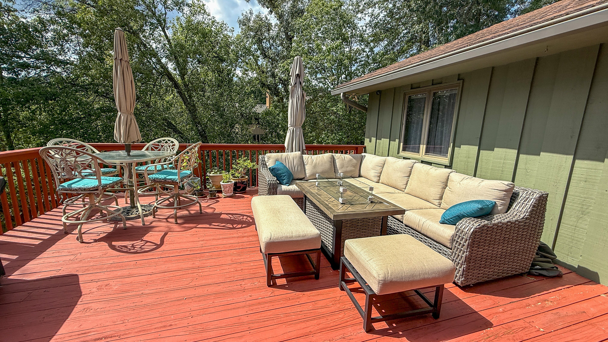 Spacious outdoor deck with lounge seating, dining space, and wooded views at the home of Sponsored Residential Providers Anna Robertson and Christopher Pietrzyk in Roanoke, VA.