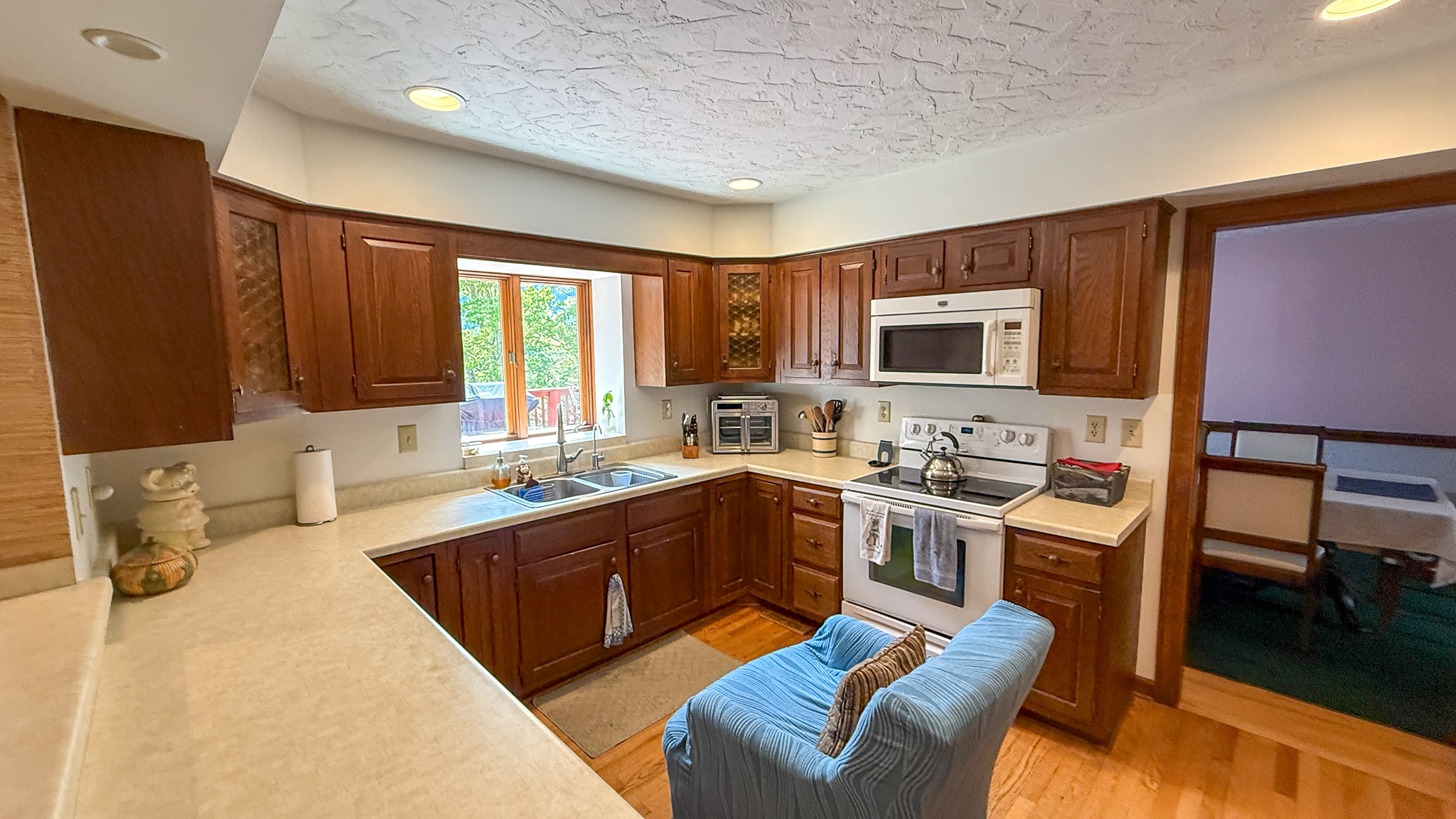 Spacious kitchen with wood cabinetry, ample counter space, and hardwood floors inside the home of Sponsored Residential Providers Anna Robertson and Christopher Pietrzyk in Roanoke, VA.