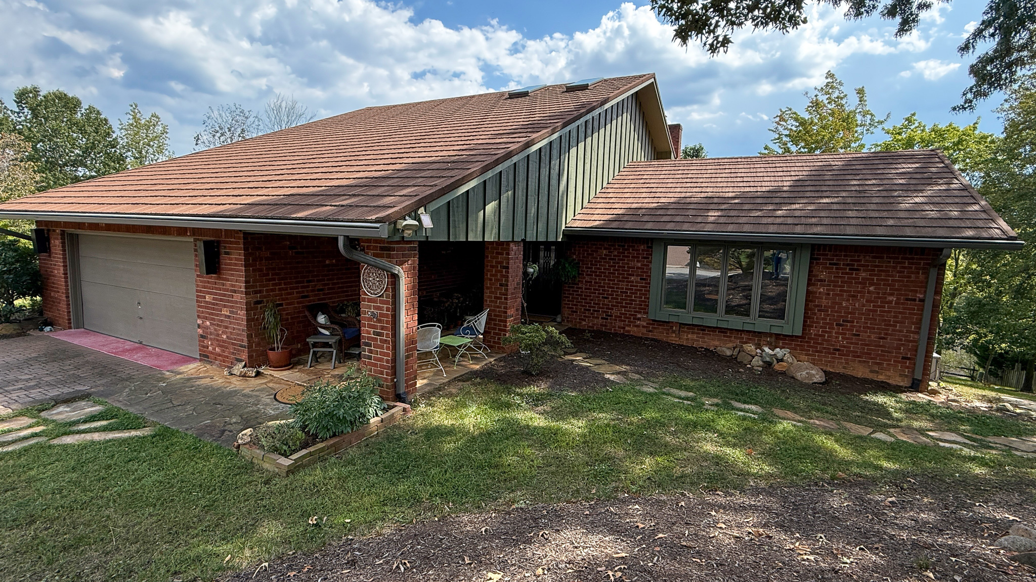 Exterior view of the brick home with an attached garage and landscaped yard of Sponsored Residential Providers Anna Robertson and Christopher Pietrzyk in Roanoke, VA.