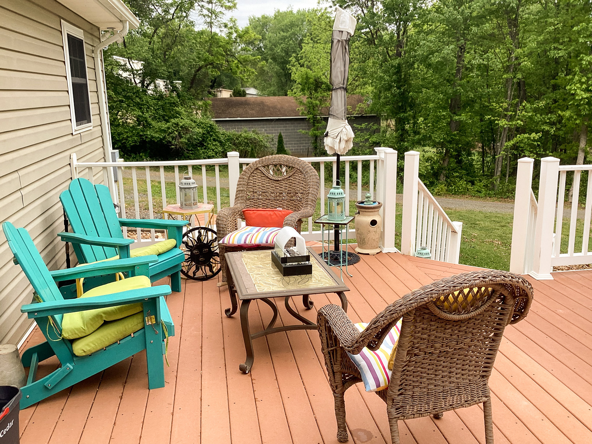 Cheerful deck with comfortable seating, colorful chairs, and a table for gathering at the home of Sponsored Residential Provider Roxane Barnes.