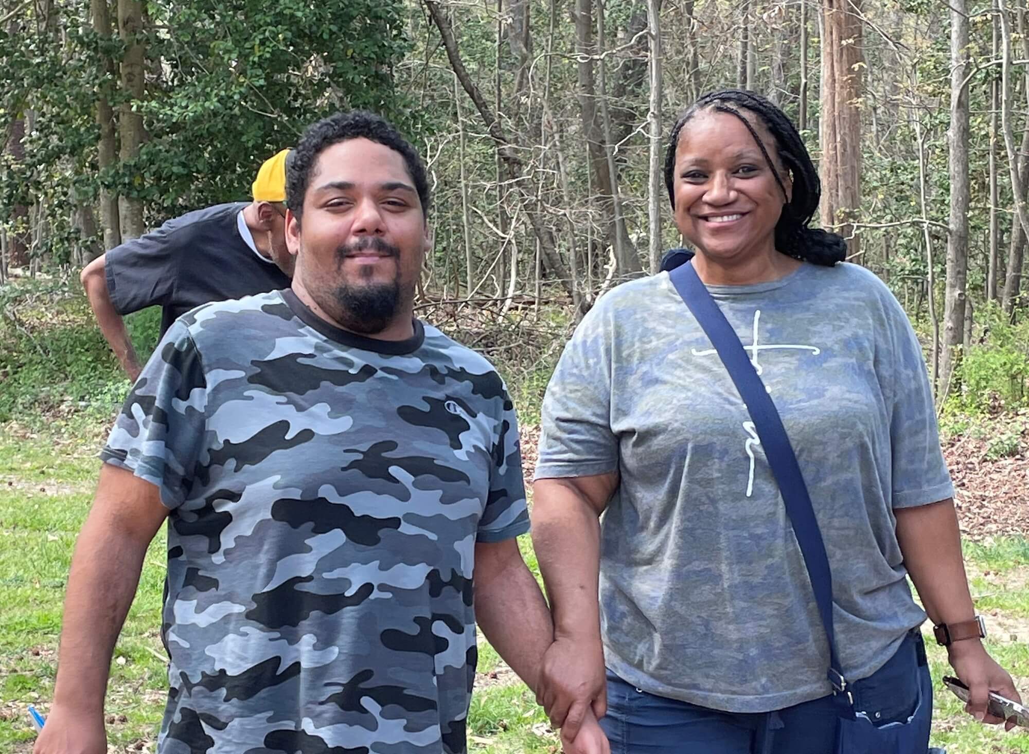 A man and woman holding hands standing outdoors