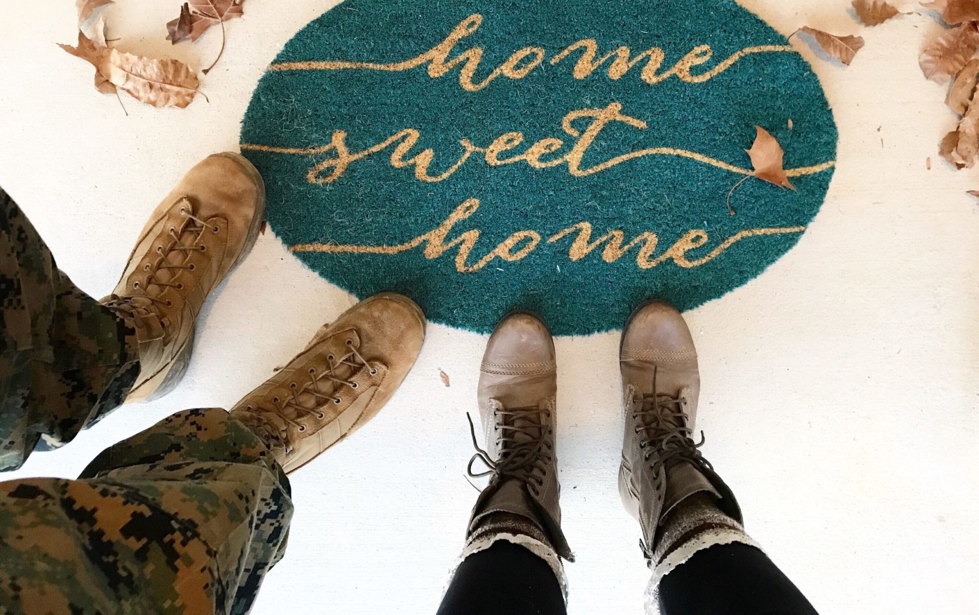 Home-sweet-home-sign-next-to-person-wearing-military-combat-boots-and-another-person-wearing-laced-up-boots.
